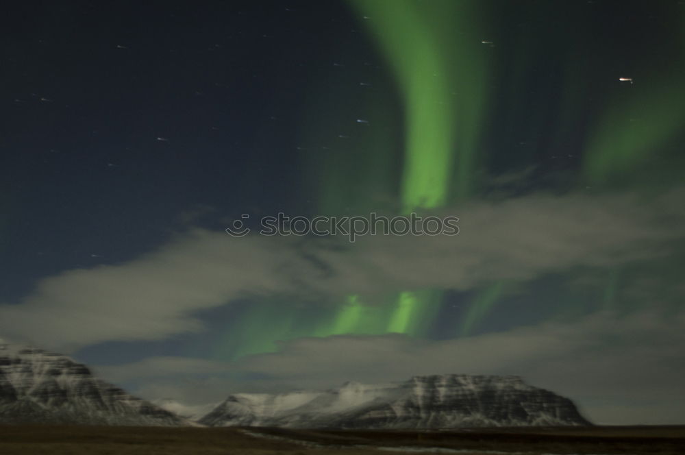 Similar – Northern lights before mountain silhouette