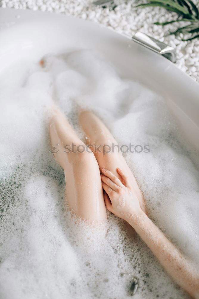 Similar – Woman lying in bathtub filled with flowers and fruits