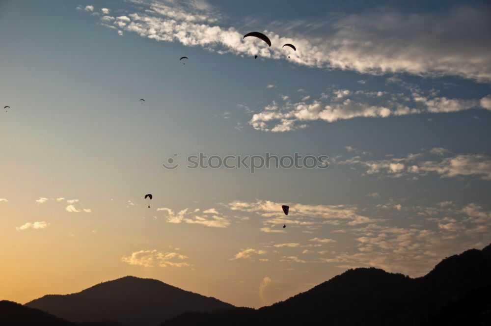 Similar – Image, Stock Photo Paragliding in the sunset at the sea