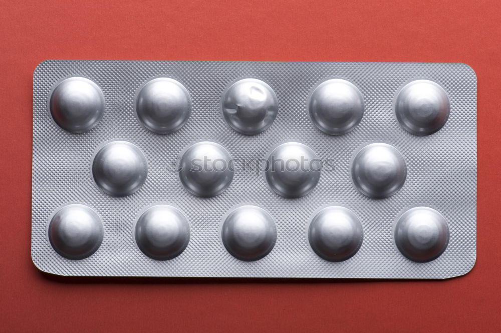 Similar – Pink round tablets pills in blister pack on pink background. Painkiller medicine. Take pill. Pharmacy product package. Pharmaceutical industry. Prescription drugs. Tablets pills for relieve pain.