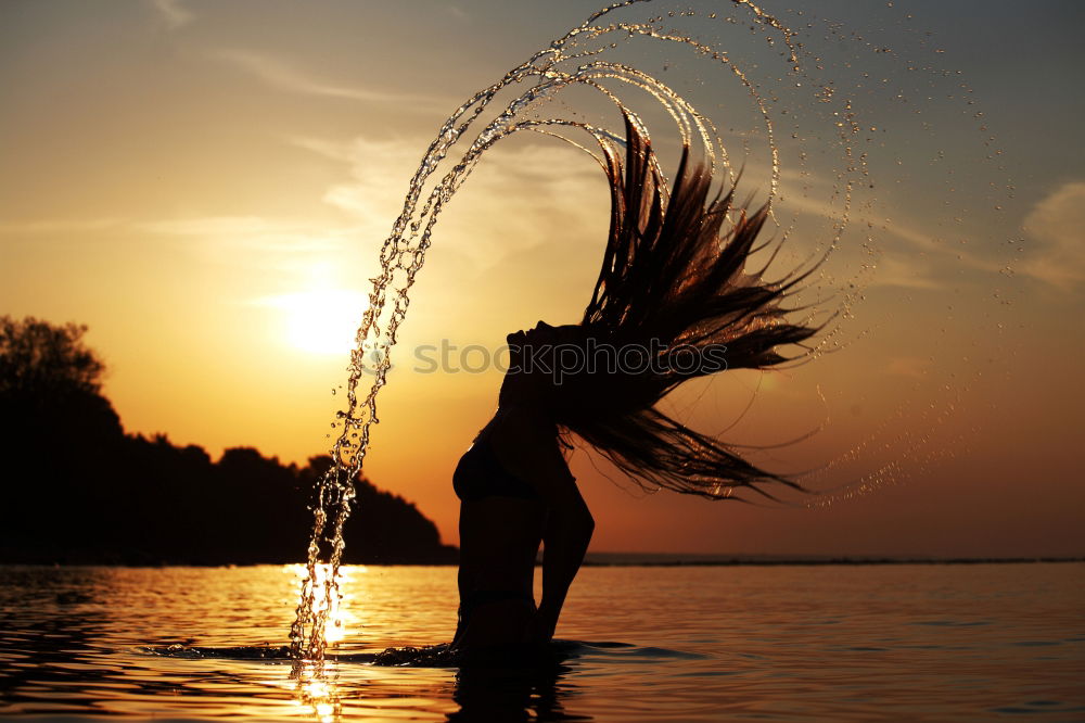 One happy little boy playing on the beach at the sunset time. Kid having fun outdoors. Concept of summer vacation.