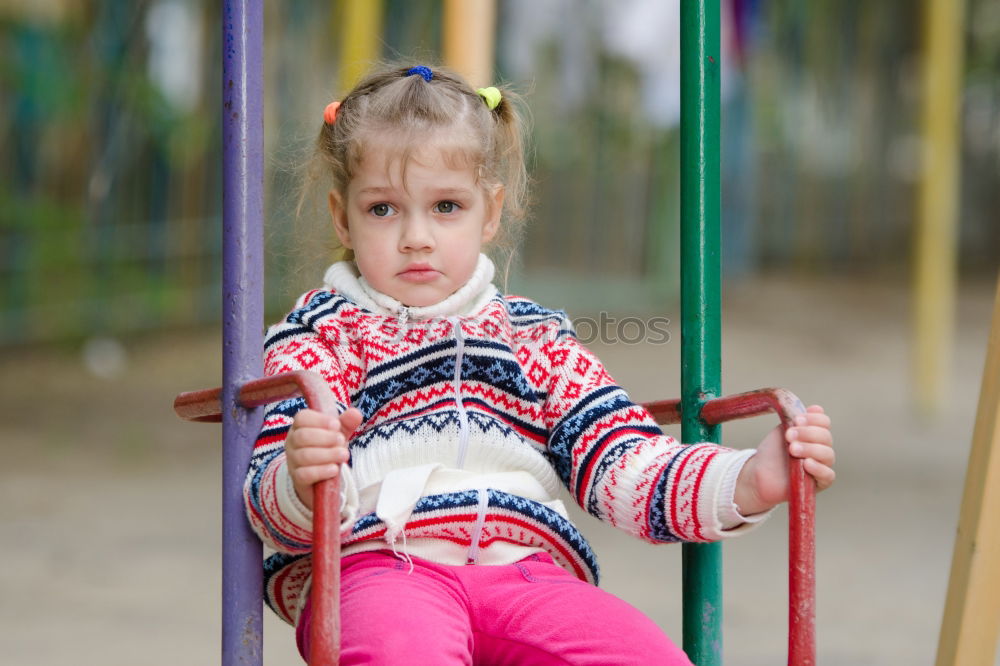 Similar – Image, Stock Photo Small baby playing with toy sitting on the ground in the park and looking to the camera