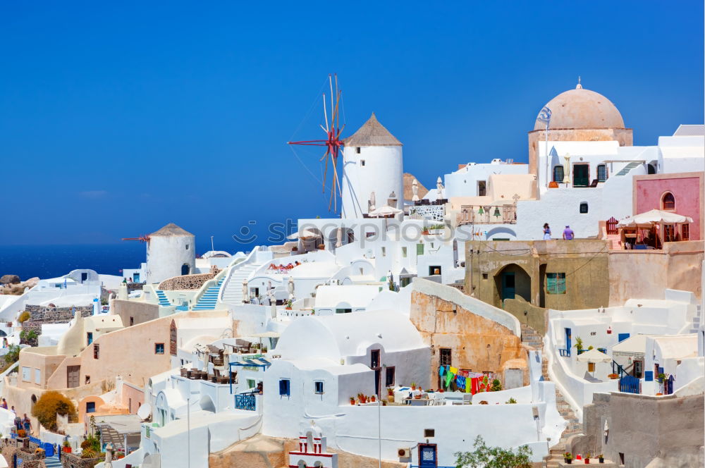 Similar – Image, Stock Photo Idyllic white houses on Santorini with windmills in front of blue sky