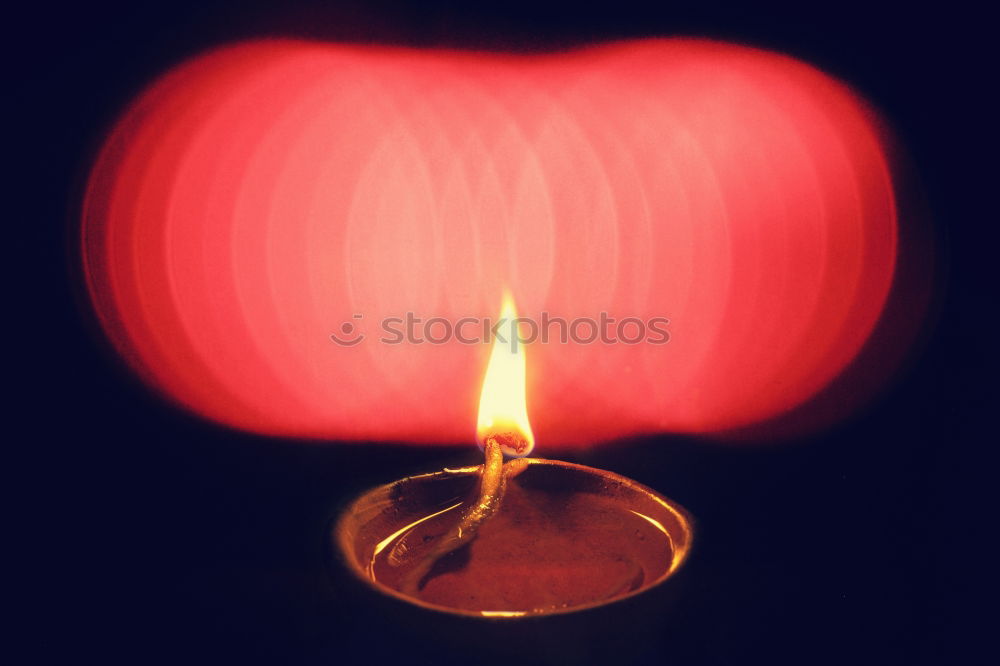 Similar – Image, Stock Photo two red burning candles stand one behind the other in front of a turquoise background