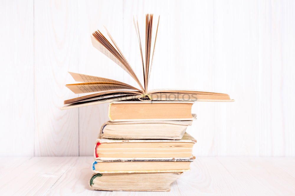 Similar – Woman turning pages of book on table in antique bookstore