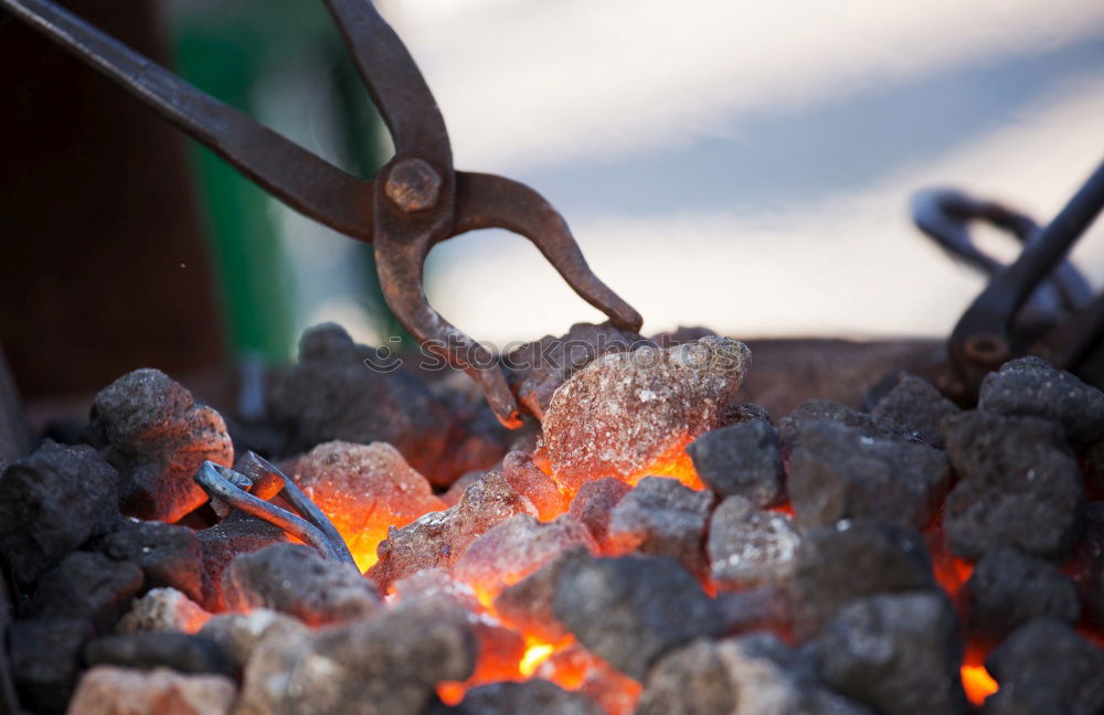 Similar – Blacksmith forges iron on anvil