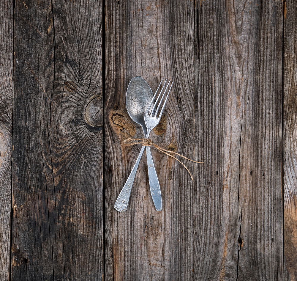 Similar – cutlery on the gray wooden surface