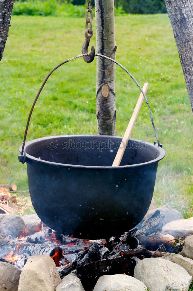 Similar – Image, Stock Photo Goulash beeing cooked in a cauldron over an open fire on a picnic.