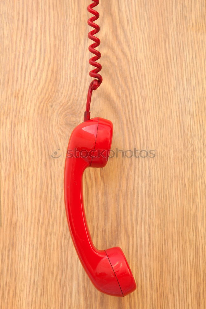 Similar – Part of an old red telephone with handset and ringed cord