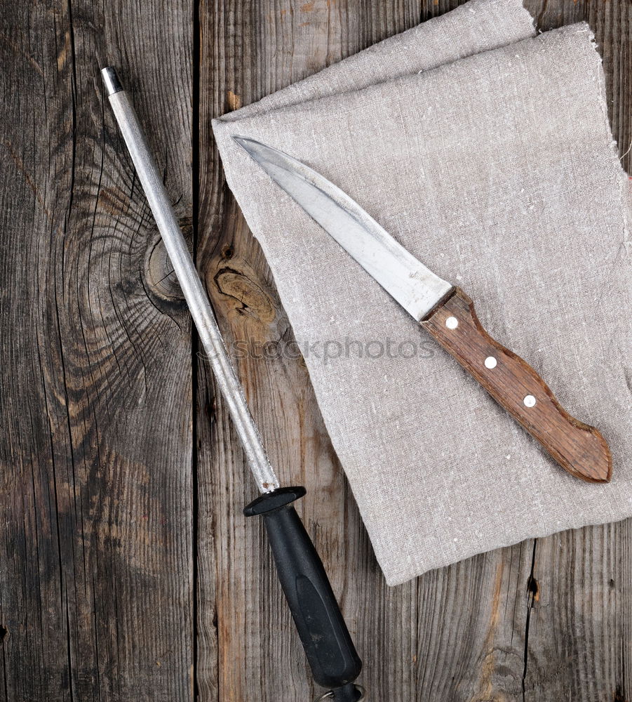 Similar – kitchen brown cutting board with handle and knife