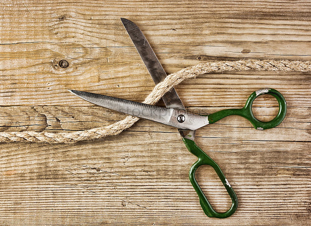 Similar – Pliers and twine on a plank