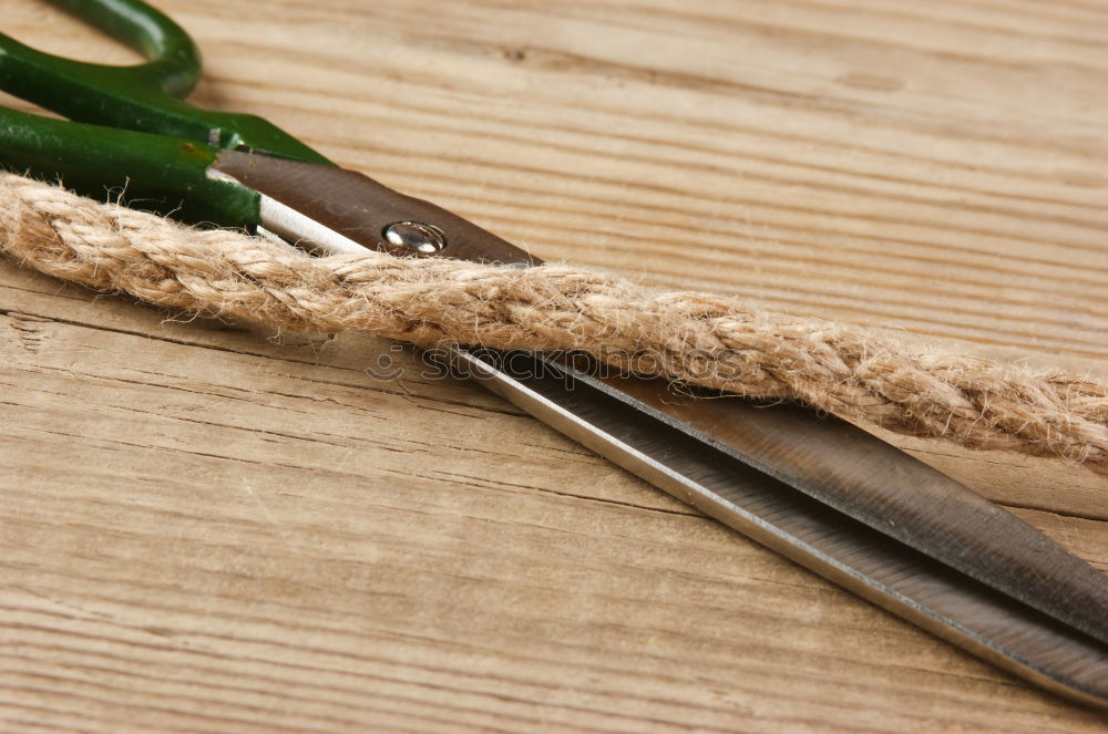 Similar – Pliers and twine on a plank