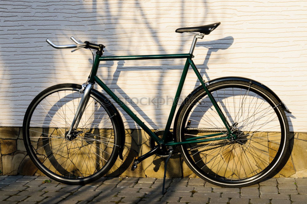 Yellow vintage road bike with U-lock connected to road sign