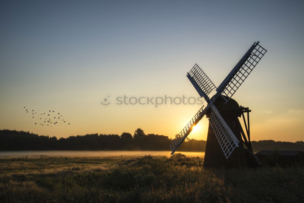 Similar – charming windmill by river at sunrise