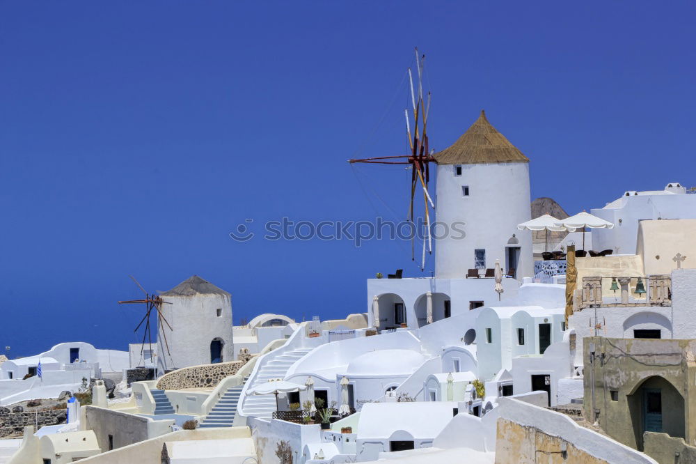 Similar – Image, Stock Photo Idyllic white houses on Santorini with windmills in front of blue sky