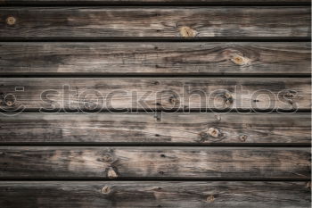 Brown wooden background with black frying pan