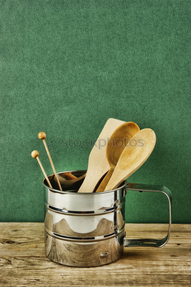 Similar – Black frying pan with a kitchen spatula, brown surface