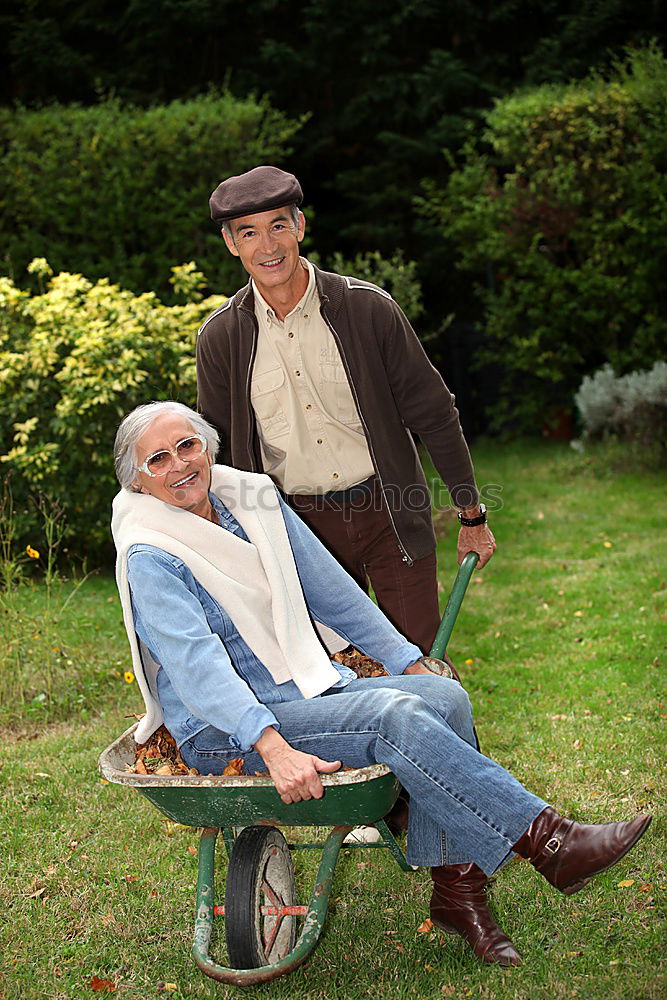 Similar – Image, Stock Photo Portrait of two laughing seniors, one with silver-grey curls and glasses, the other with cap in front of an old wall