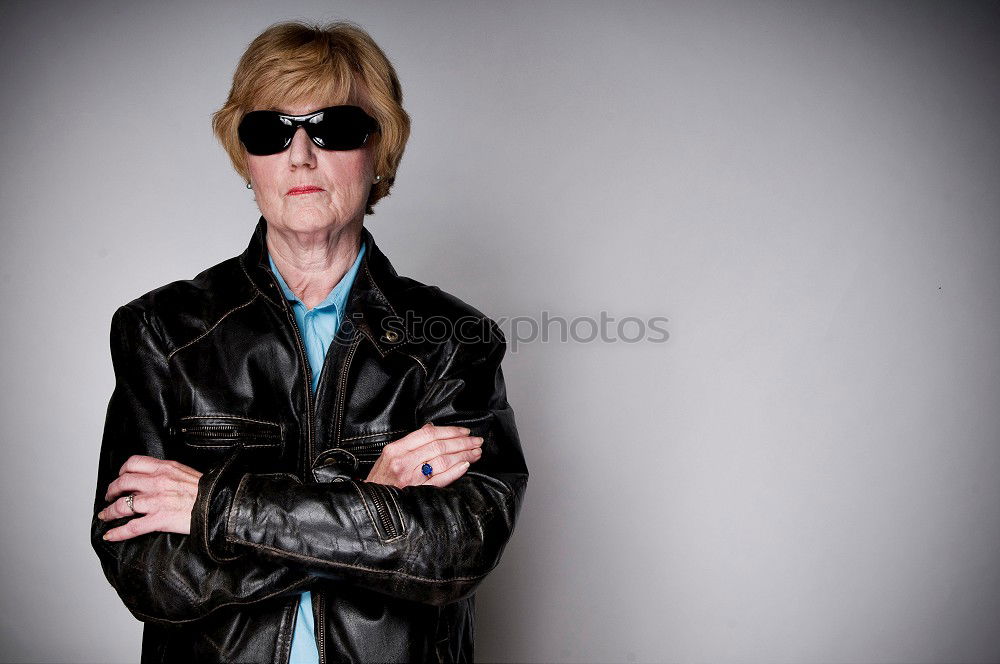 Similar – Portrait of senior woman with sunglasses insulting with finger