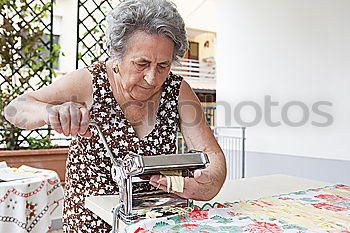 Similar – Senior woman sewing protective masks at home