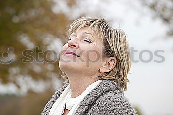 Similar – Happy senior woman sitting on the grass