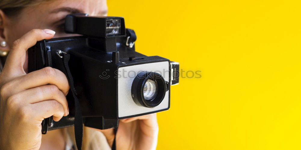 Young woman taking pictures with an instant camera