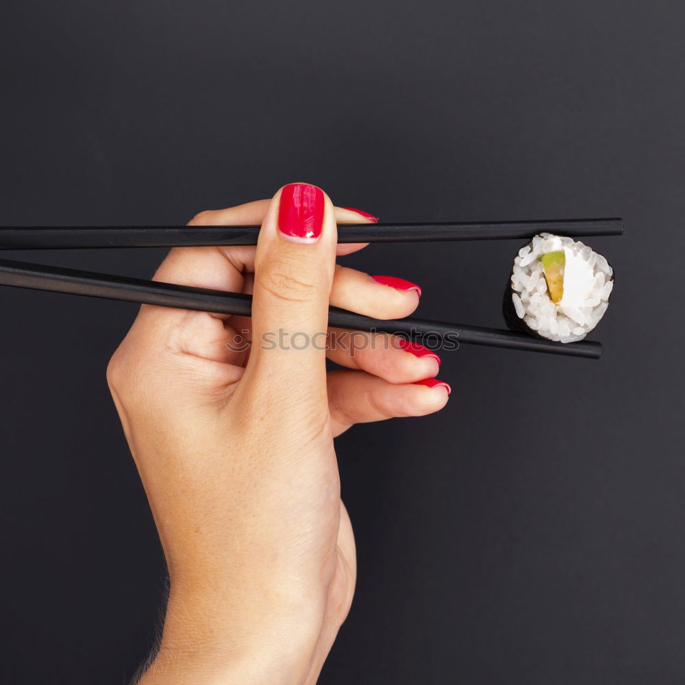 Crop woman eating sushi