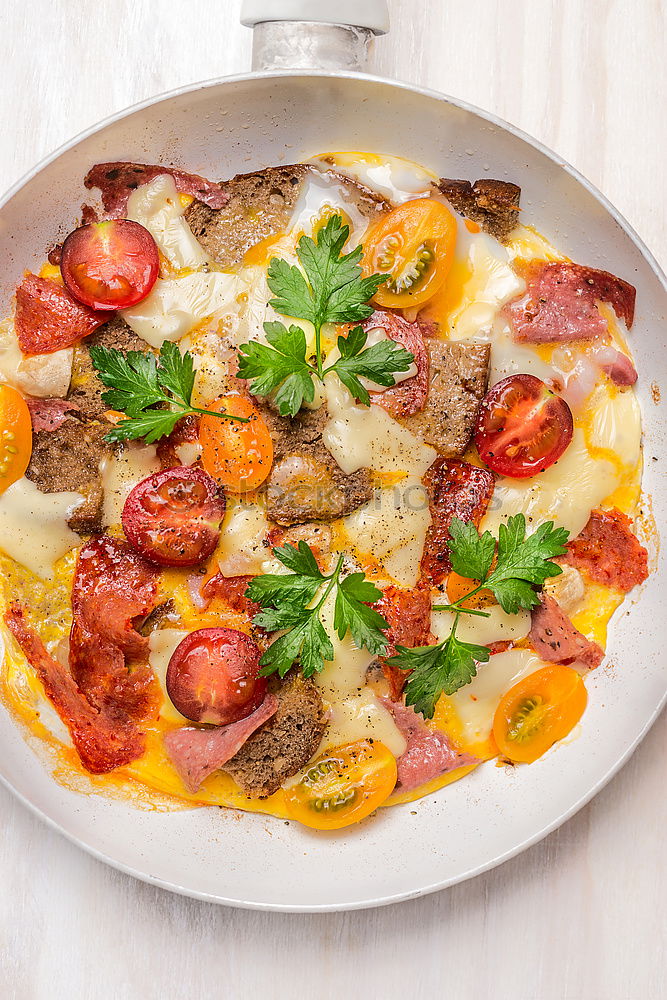 Similar – Omelette with sausage, tomatoes, bread and cheese