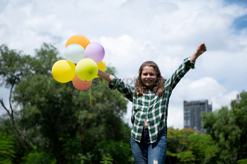 Similar – young woman with balloon on the mountain at a city