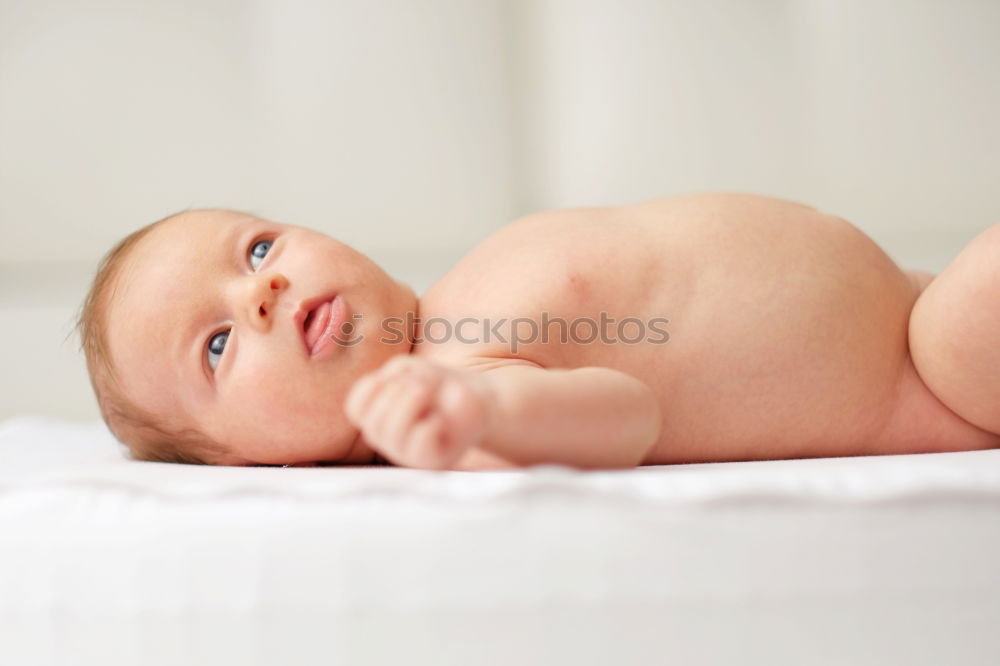 Similar – Cute Baby Girl Lying in the Baby Changer.