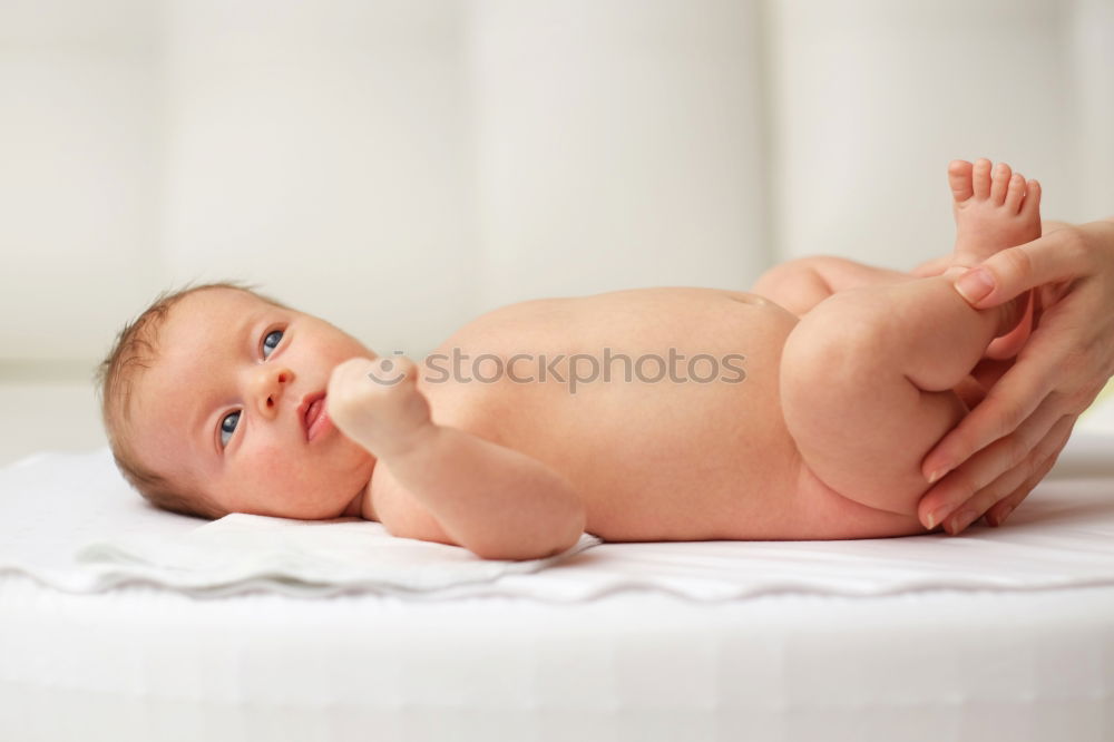 Similar – Cute Baby Girl Lying in the Baby Changer.