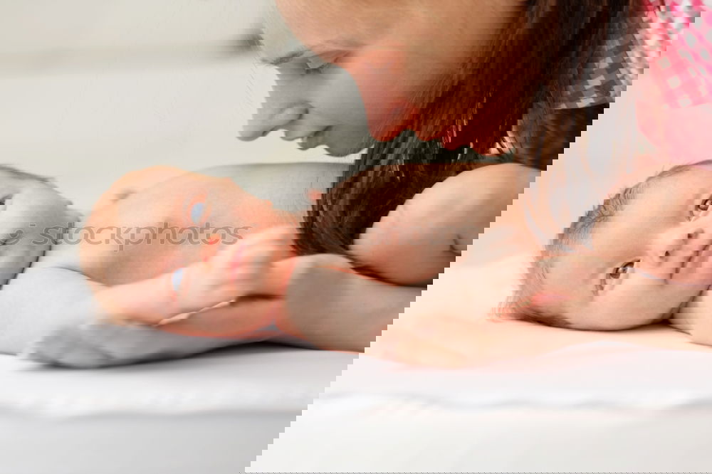 Image, Stock Photo Newborn lying over bed and couple smiling on background
