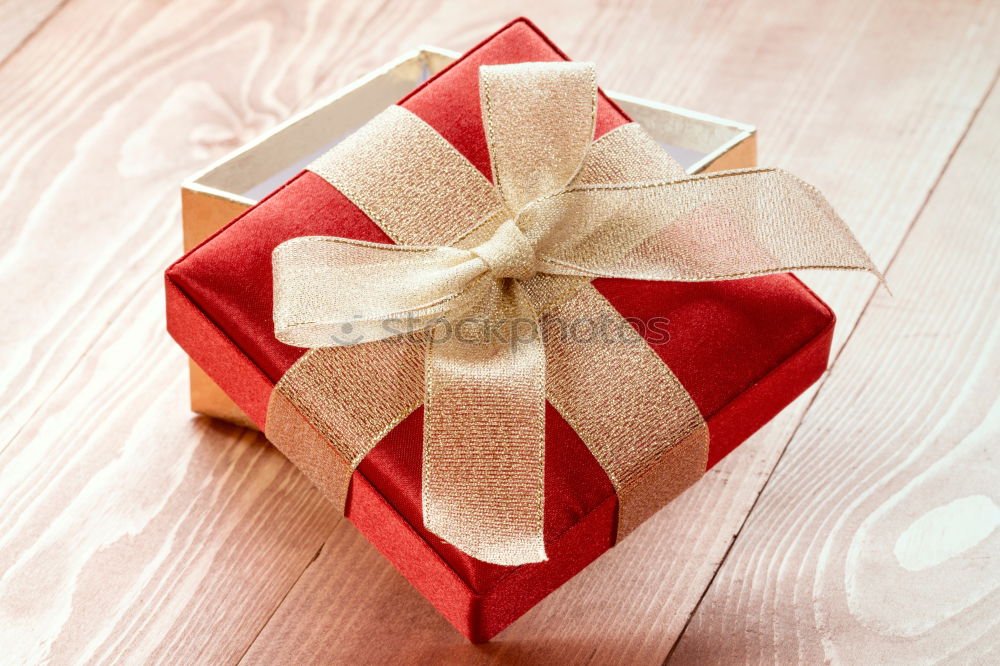 Similar – Gift box wrapped in recycled paper, red bow and tag