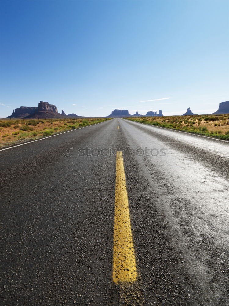 Similar – Fahrbahnmarkierungen eines amerikanischen Highways aus nächster Nähe an einem sonnigen Tag mit blauem Himmel.