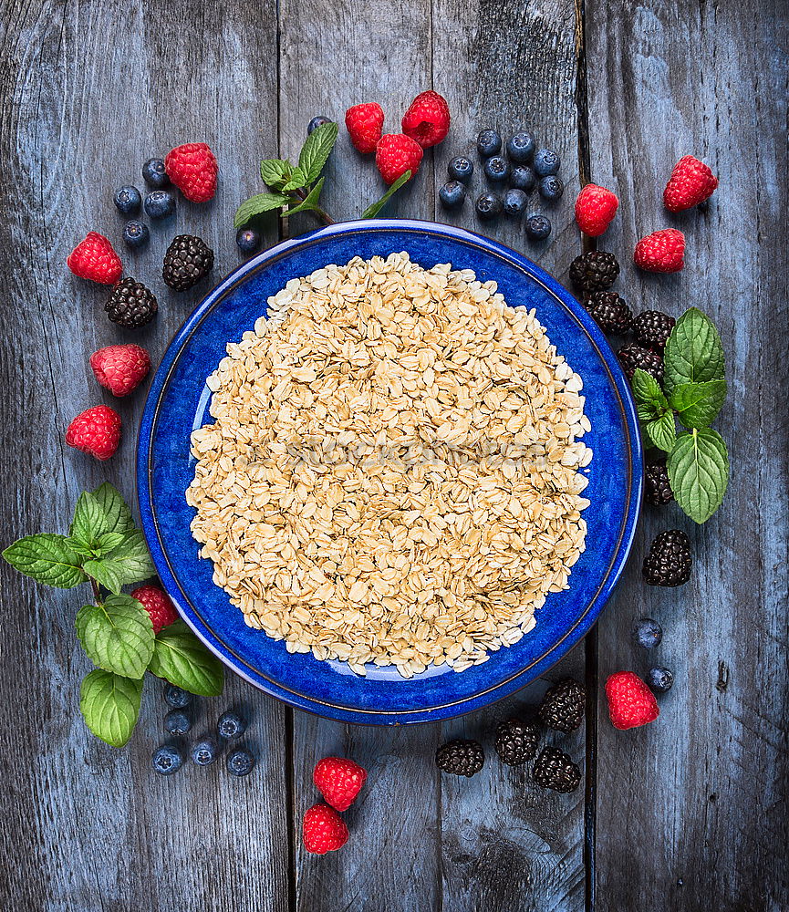 Oat flakes in blue bowl with berries