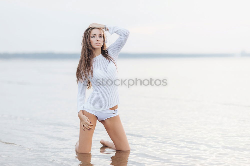 Similar – Image, Stock Photo Backlit portrait of a young woman in a summer dress standing with her feet in water