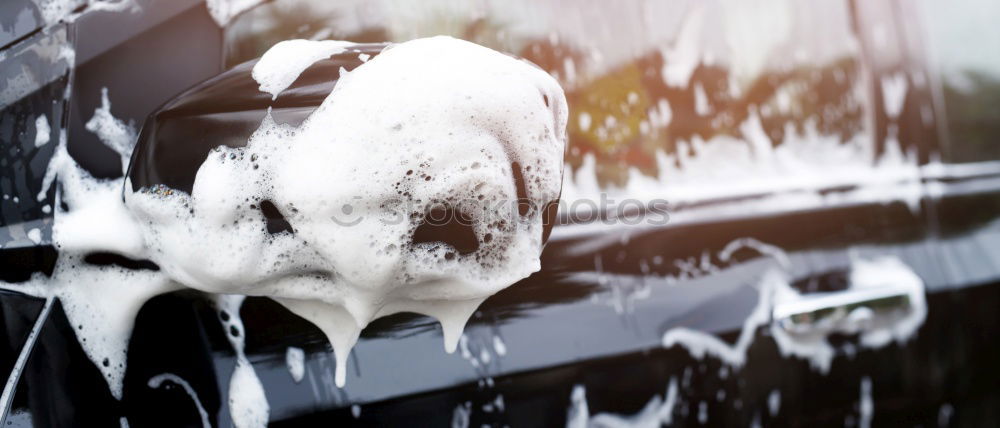 Similar – Whoosh!!! There thunders the dark car full through a deep puddle. A huge shower of water drenches the pedestrian with a colorful umbrella and red rubber boots.