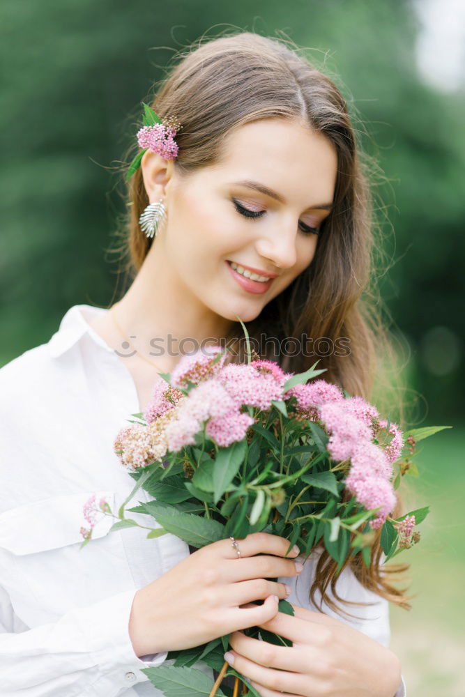 Similar – Pretty woman standing with white flowers