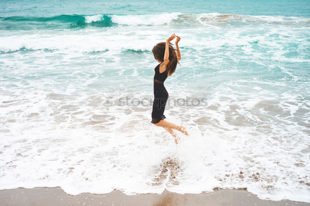 Young female athlete doing exercise on beach