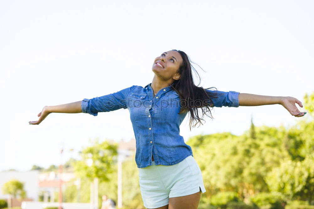 Similar – Women wearing t-shirt and jeans stays outdoor in the park