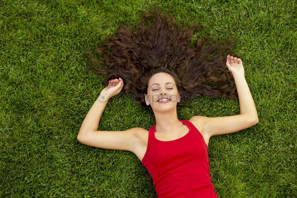 Similar – young cheerful woman lying down on the grass