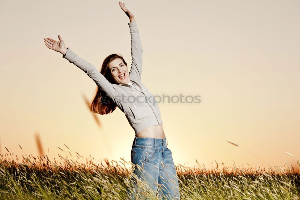 Similar – Young woman with her arms raised to the sky