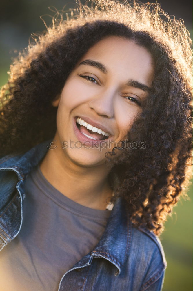 Similar – close up of a pretty black woman with curly hair smiling and lying on bed looking away