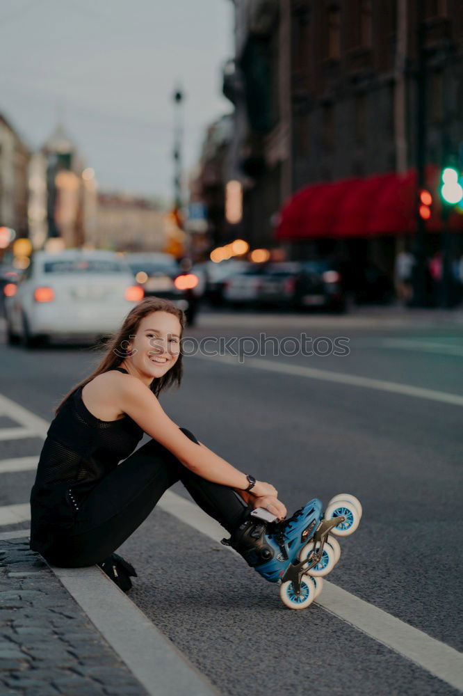 Similar – Happy female riding skate board in street