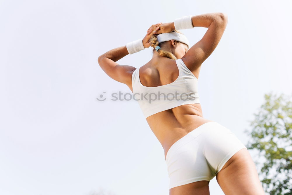 Similar – Young sporty woman doing exercises with a latex band