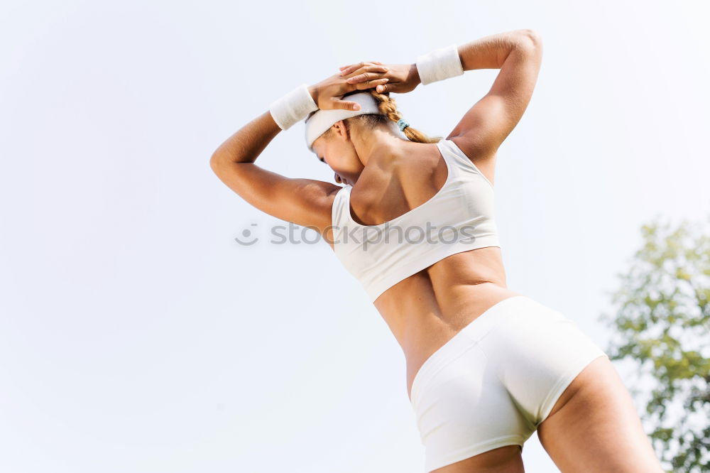 Similar – Young sporty woman doing exercises with a latex band