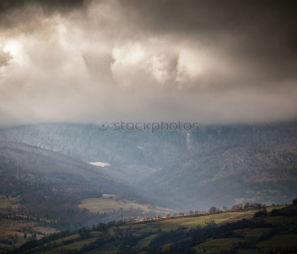 Similar – Mountain autumn landscape with colorful forest. Clouds of fog.