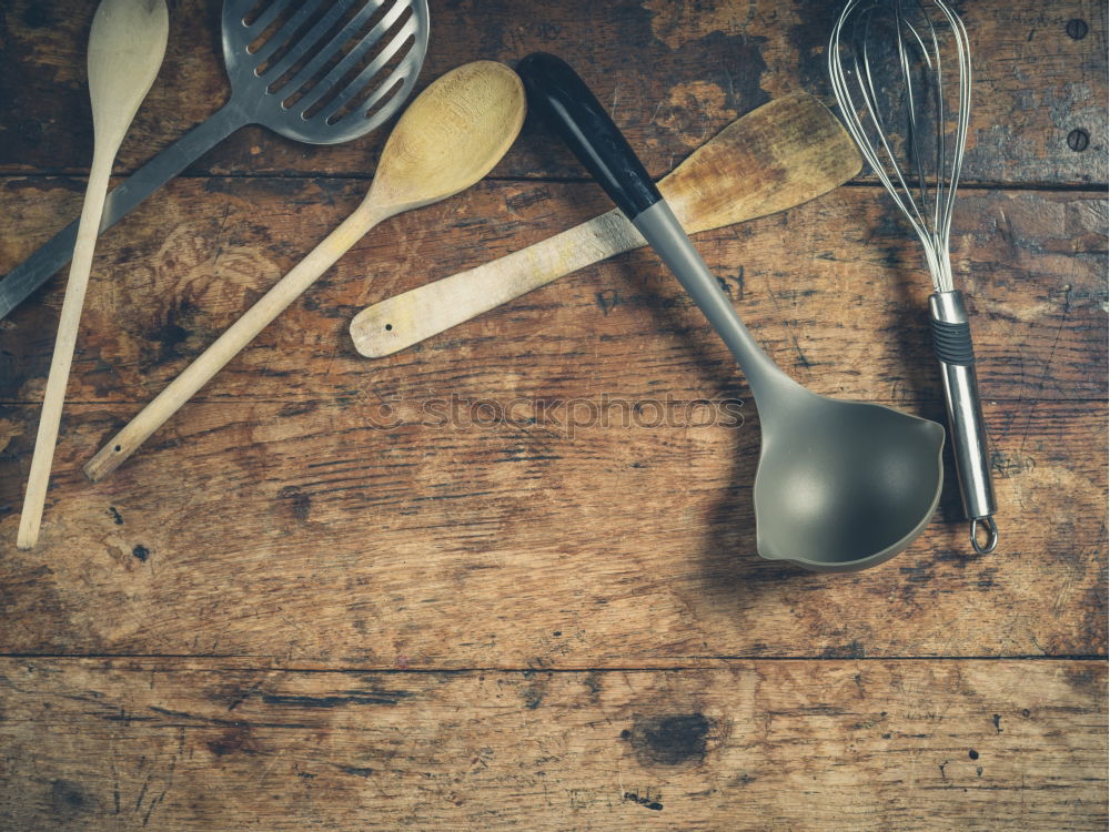 Similar – Black frying pan with a kitchen spatula, brown surface