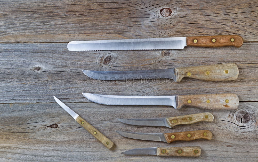 Similar – wooden cutting board and knife with sharpening on the table