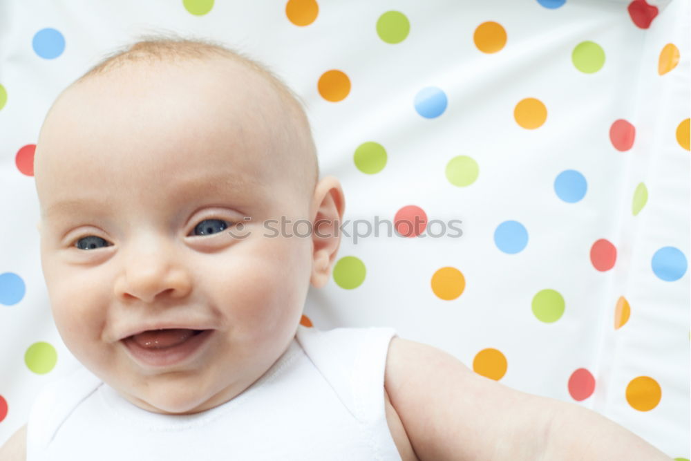 Similar – Little baby girl lying on blanket with colourful polka dots